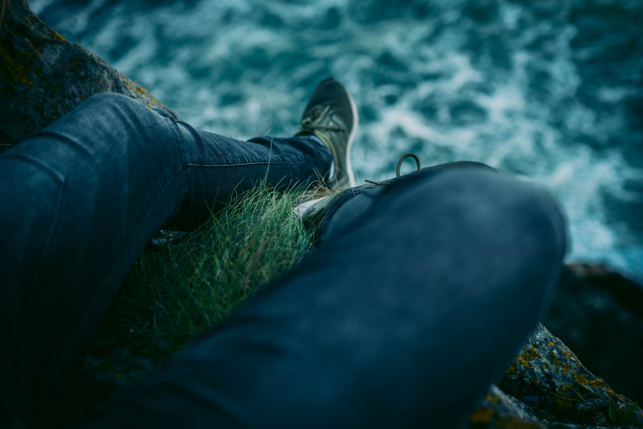 Person sitting on a cliff